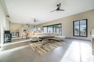 a living room with a couch and a table at Lotus Villa-Cozy 3BR in Canggu in Kerobokan