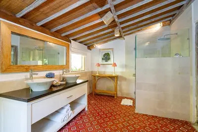 a bathroom with two sinks and a shower at The Orchard house Bali by Puri Asia in Seminyak