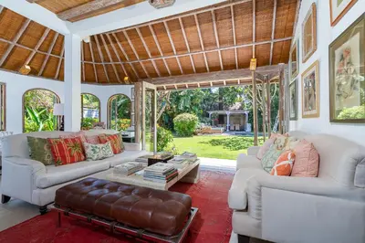 a living room with two couches and a table at The Orchard house Bali by Puri Asia in Seminyak