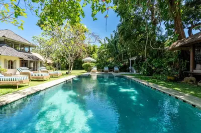 a swimming pool in the backyard of a house at The Orchard house Bali by Puri Asia in Seminyak