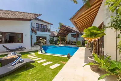 a backyard with a swimming pool and a house at Philana Cozy 3 BR Private Pool Villa in Seminyak