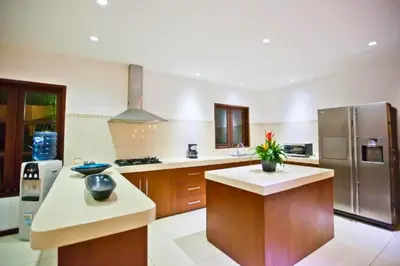 a large kitchen with a stainless steel refrigerator at Philana Cozy 3 BR Private Pool Villa in Seminyak