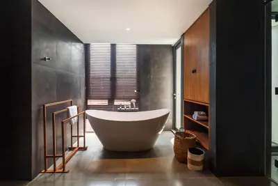 a bathroom with a large tub and a sink at Santos Cliff View Jimbaran in Jimbaran