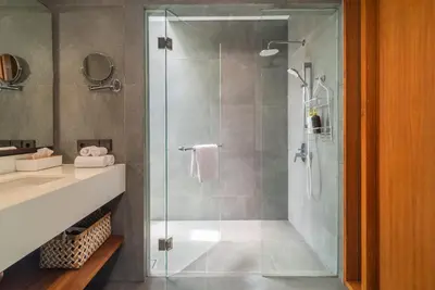 a bathroom with a shower with a glass door at Santos Cliff View Jimbaran in Jimbaran
