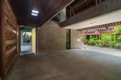 an empty lobby of a house with a large glass door at Santos Cliff View Jimbaran in Jimbaran