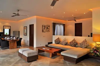a living room with a couch and a table at Fidela Comfortable 3 BR Private Pool Villa in Seminyak