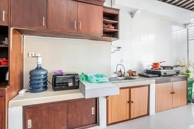 a kitchen with a sink and a microwave at Cening Villa Seminyak in Seminyak