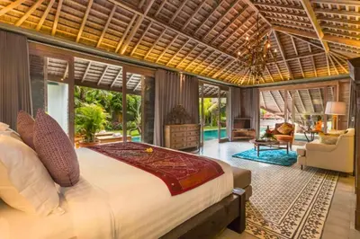 a bedroom with a large bed in a room at Kalysta Spacious 4 BR Private Pool Villa in Canggu