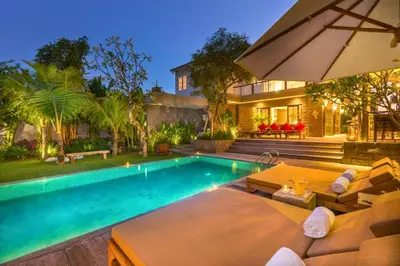 a home with a swimming pool and a house at Kalysta Spacious 4 BR Private Pool Villa in Canggu