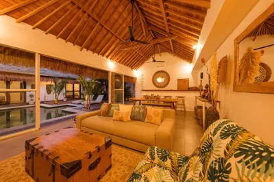 a living room with a couch and a table at Tropical 2BR Pool Villa near Seminyak & Canggu in Kerobokan