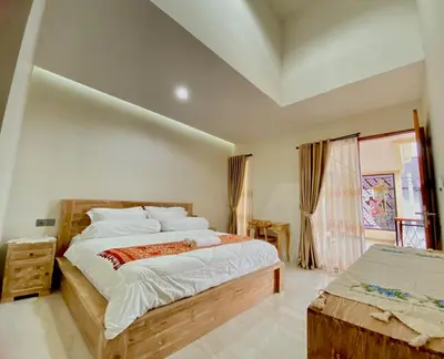 a bedroom with a large bed and a window at quiet and comfortable villa in sanur kauh in Sanur