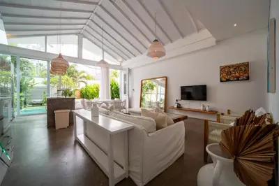 a living room with white furniture and a large window at Luxury 2BR Dharma Villa 5 Private Pool in Canggu in Canggu