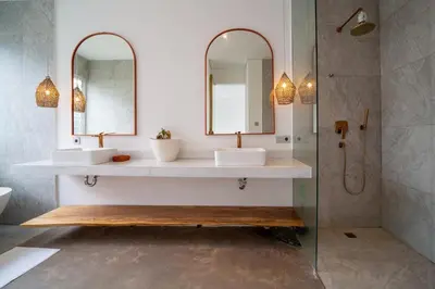 a bathroom with two sinks and two mirrors at Luxury 2BR Dharma Villa 5 Private Pool in Canggu in Canggu