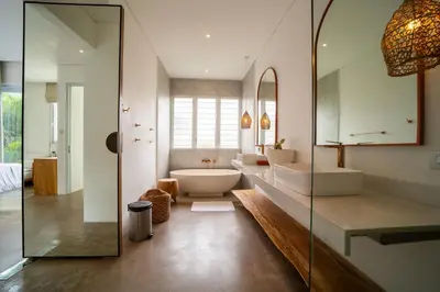 a bathroom with two sinks and a tub and a mirror at Luxury 2BR Dharma Villa 5 Private Pool in Canggu in Canggu