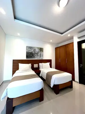 two beds in a hotel room with two bedsvisor at Kubu Manggala Villas Seminyak in Seminyak