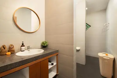 a bathroom with a sink and a mirror at Red Lotus Seminyak Villa in Seminyak