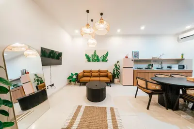 a living room with a table and a couch at Villa Gadang in Kerobokan