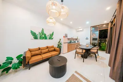 a living room with a couch and a table at Villa Gadang in Kerobokan