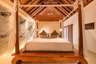 a bed in a room with a wooden ceiling at Luxury 1BR Villa with Private Pool in Seminyak in Seminyak