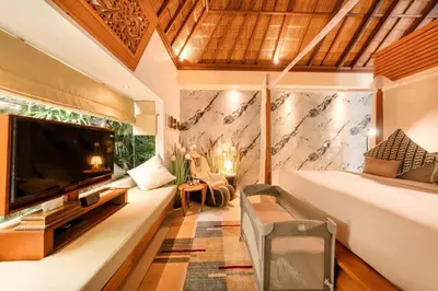 a bedroom with a large screen tv and a bed at Luxury 1BR Villa with Private Pool in Seminyak in Seminyak