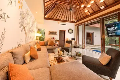 a living room with a couch and a tv at Luxury 1BR Villa with Private Pool in Seminyak in Seminyak