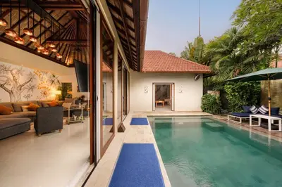a house with a swimming pool and a living room at Luxury 1BR Villa with Private Pool in Seminyak in Seminyak