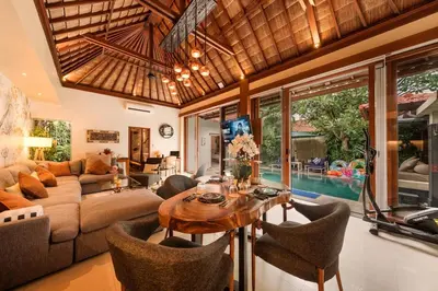 a living room with a couch and a table and chairs at Luxury 1BR Villa with Private Pool in Seminyak in Seminyak