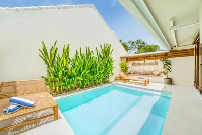 an indoor swimming pool with a patio and a pool house at 3BR Villa | Seminyak Central | 450m From Beach in Seminyak