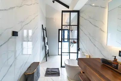 a bathroom with a tub and a toilet and a sink at Seminyak Loft 360 by Villas R Us in Seminyak