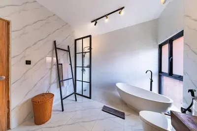 a white bathroom with a tub and a sink at Seminyak Loft 360 by Villas R Us in Seminyak