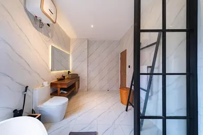 a bathroom with a toilet and a wooden table at Seminyak Loft 360 by Villas R Us in Seminyak