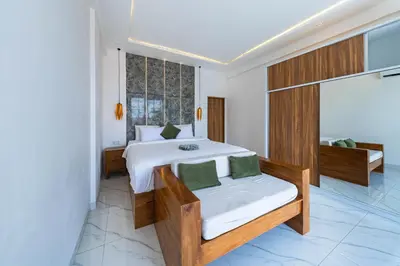 a bedroom with a bed and a large window at Seminyak Loft 360 by Villas R Us in Seminyak