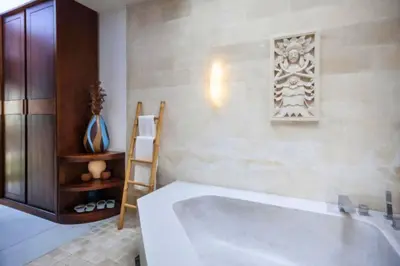 a bathroom with a large white tub and a ladder at Ekavira Peaceful 2 BR Private Pool Villa in Seminyak