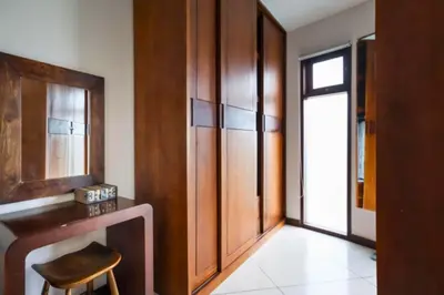 a room with a table and a stool and a mirror at Ekavira Peaceful 2 BR Private Pool Villa in Seminyak