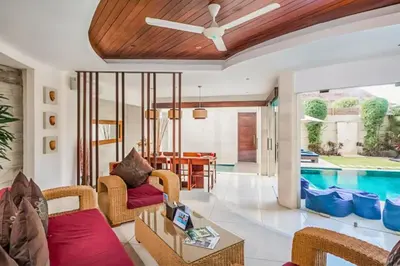 a living room with a pool and a ceiling fan at Ekavira Peaceful 2 BR Private Pool Villa in Seminyak
