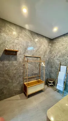 a room with a shower with a towel rack at Villa Harmaka in Kerobokan