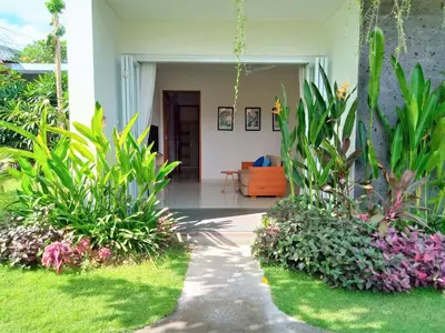 a porch of a house with plants at Harmony Beach Suite in Seminyak