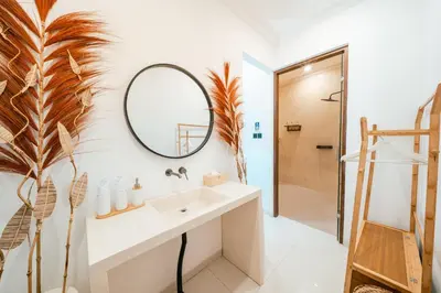 a bathroom with a sink and a mirror at Villa Tyaga in Kerobokan