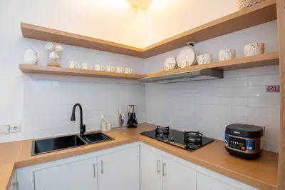 a kitchen with white cabinets and a sink at Canggu 3BR Private Pool Villa 3 min to Beach Finns in Canggu