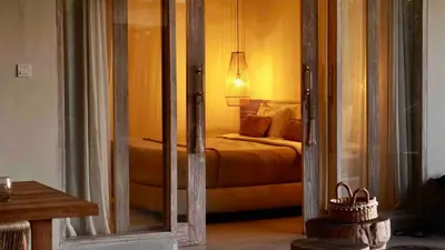 a bedroom with a bed and a mirror at Villa Marina in Canggu