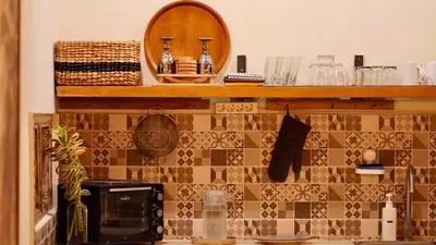 a kitchen counter with a microwave and a mirror at Villa Marina in Canggu