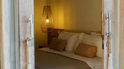 a bedroom with a bed with two pillows on it at Villa Marina in Canggu