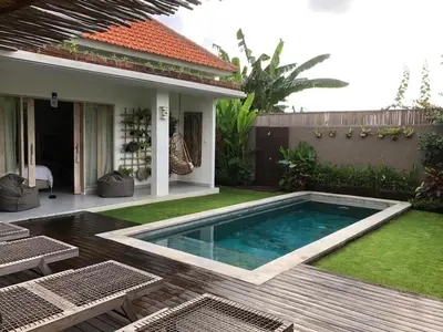 a swimming pool in the backyard of a house at Villa Marina in Canggu
