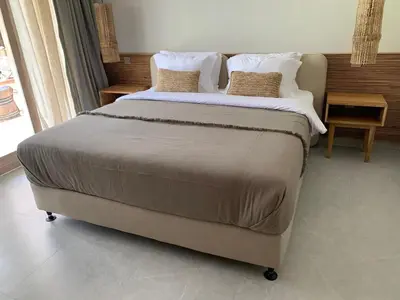 a bedroom with a large bed with two pillows at Villa Marina in Canggu