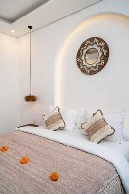 a bedroom with a large bed with a mirror on the wall at 3 Kamar Tidur Di Legian in Legian