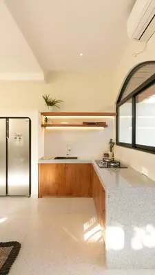 a kitchen with a sink and a refrigerator at Casa Amani 3BR Mediterranean w Pool Near Seminyak in Kerobokan