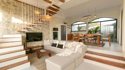 a living room with a white couch and a tv at Casa Amani 3BR Mediterranean w Pool Near Seminyak in Kerobokan