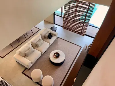 an overhead view of a living room with a couch and chairs at Villa Daun Emas in Jimbaran