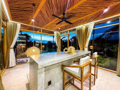 a kitchen with a large window with a ceiling fan at Desa Hut - Tropical Haven with Ricefield View near Seminyak in Kerobokan