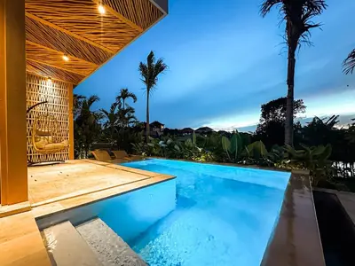 a swimming pool in a villa with a view at Desa Hut - Tropical Haven with Ricefield View near Seminyak in Kerobokan